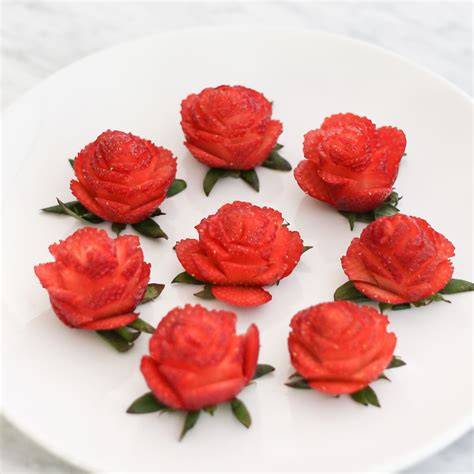 Strawberry garnish shaped like a rose on a cocktail