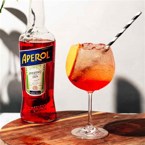 Una selezione di ingredienti per cocktail, tra cui Aperol, Campari, prosecco e soda