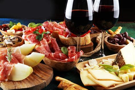 un calice di vino rosso e un tagliere di formaggi