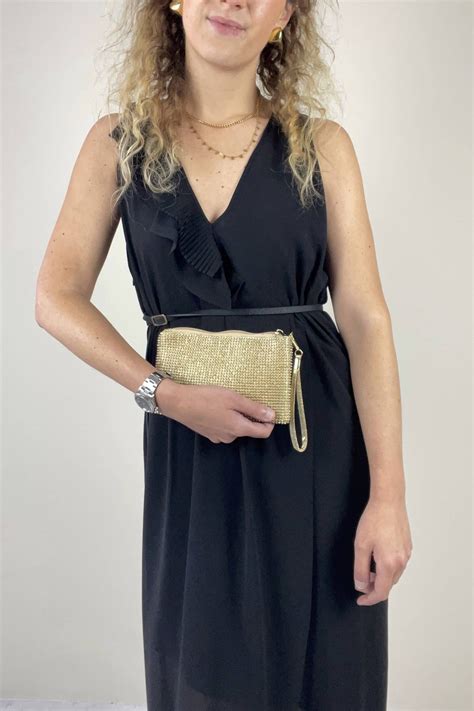 Donna che indossa una pochette strass champagne a tracolla con un abito da sera