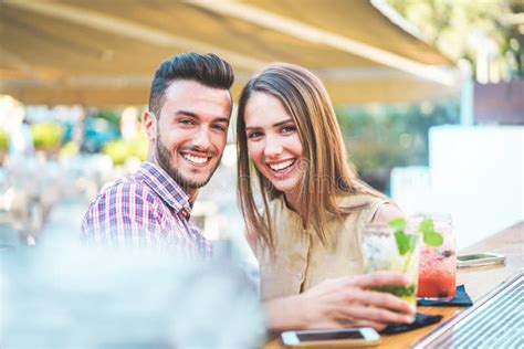 Coppia che brinda con cocktail all'aperto